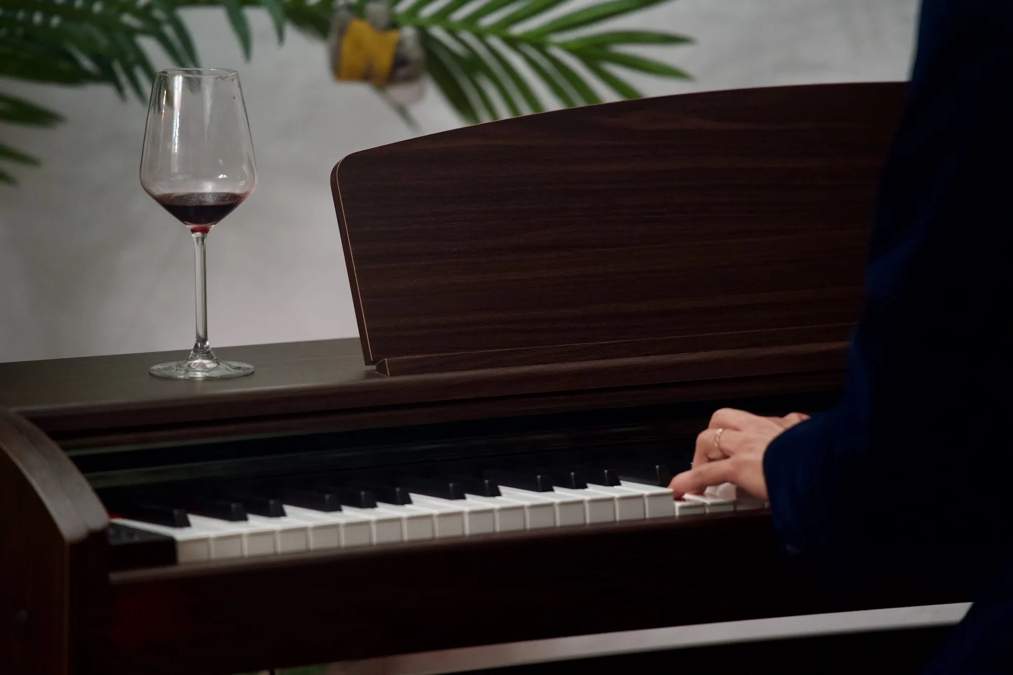 A glass of red wine on top of a digital piano, with pianist playin the piano, Tallinn Fringe Festival 2026