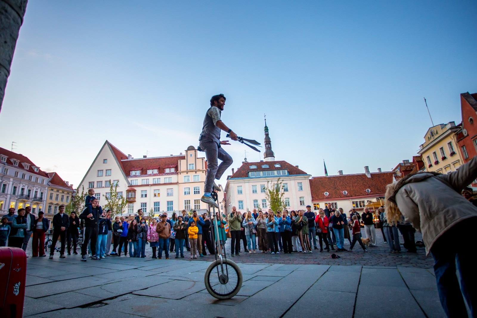 Street artist riding a unicycle in Tallinn